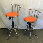 Pair of Modern Atomic Chrome Metal & Orange Vinyl Swivel Stools